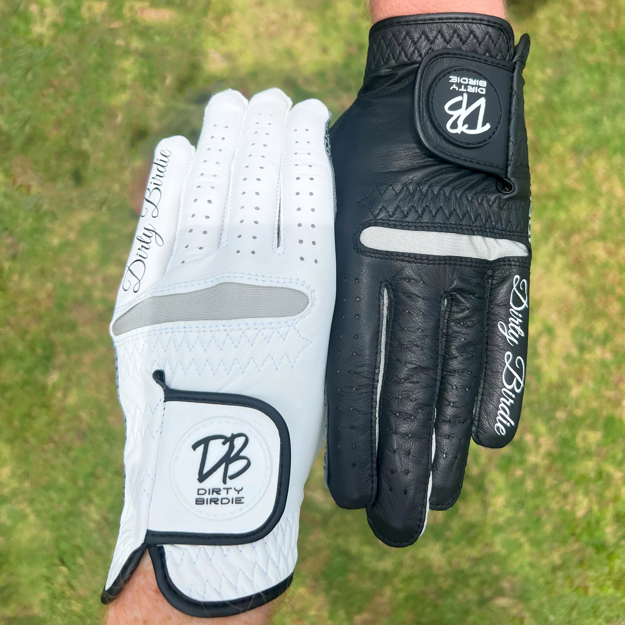 Aerial view of white and black premium cabretta leather glove on hand side by side on course