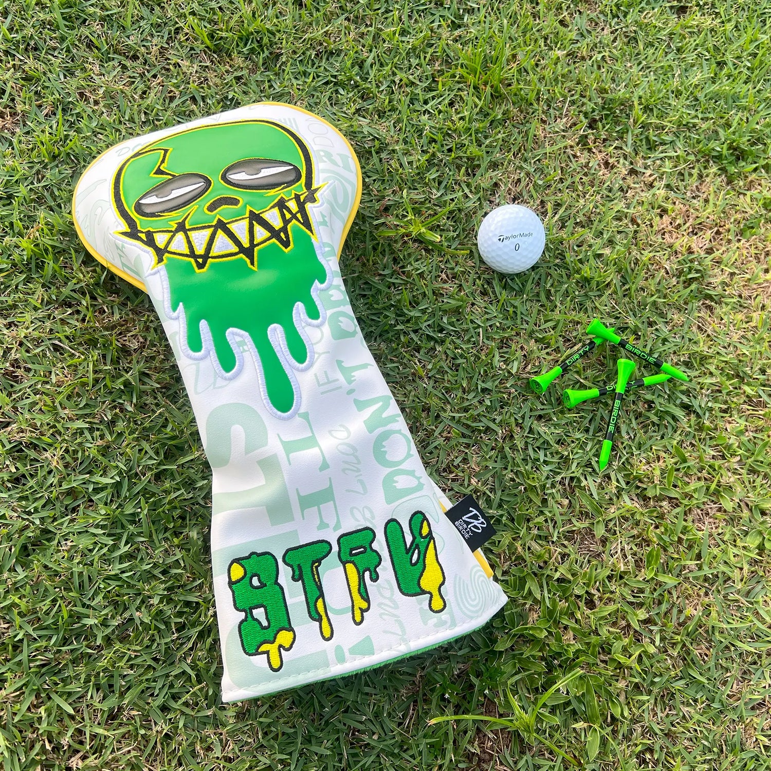 Premium STFU driver headcover on tee box with golf ball and tees beside