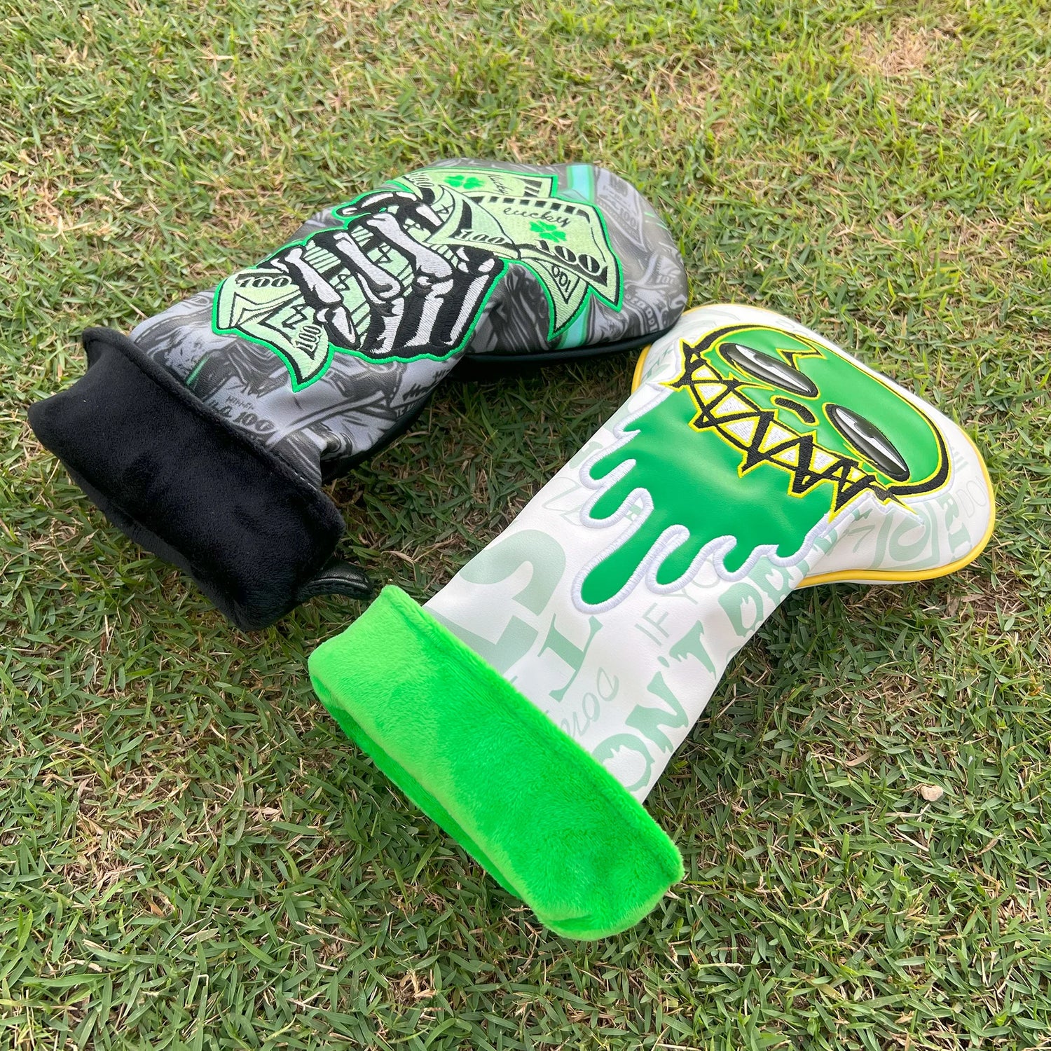 Both golf headcovers laid flat showing detailed embroidery and plush interior lining