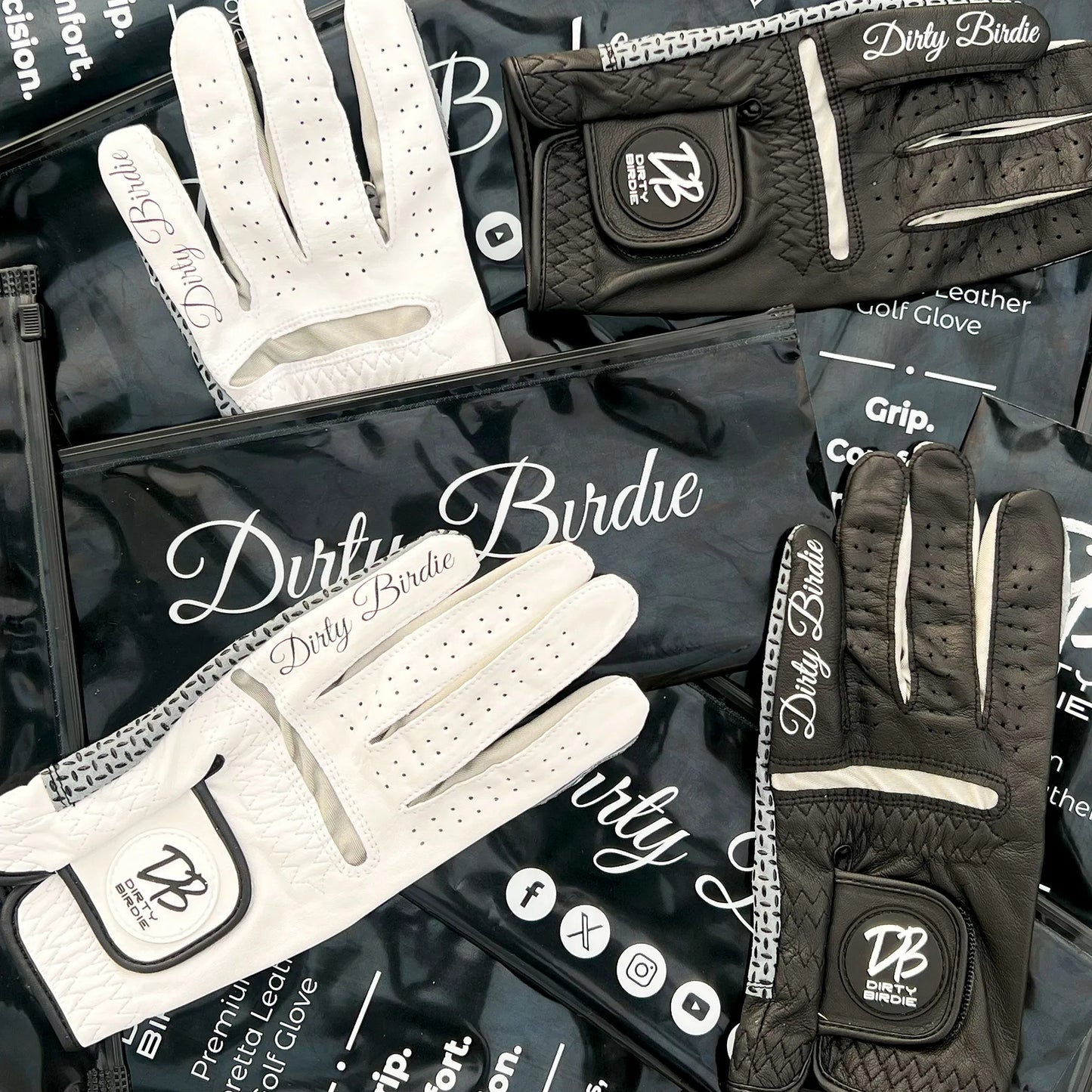Black and white premium cabretta leather glove laying on top of dirty birdie custom packaging