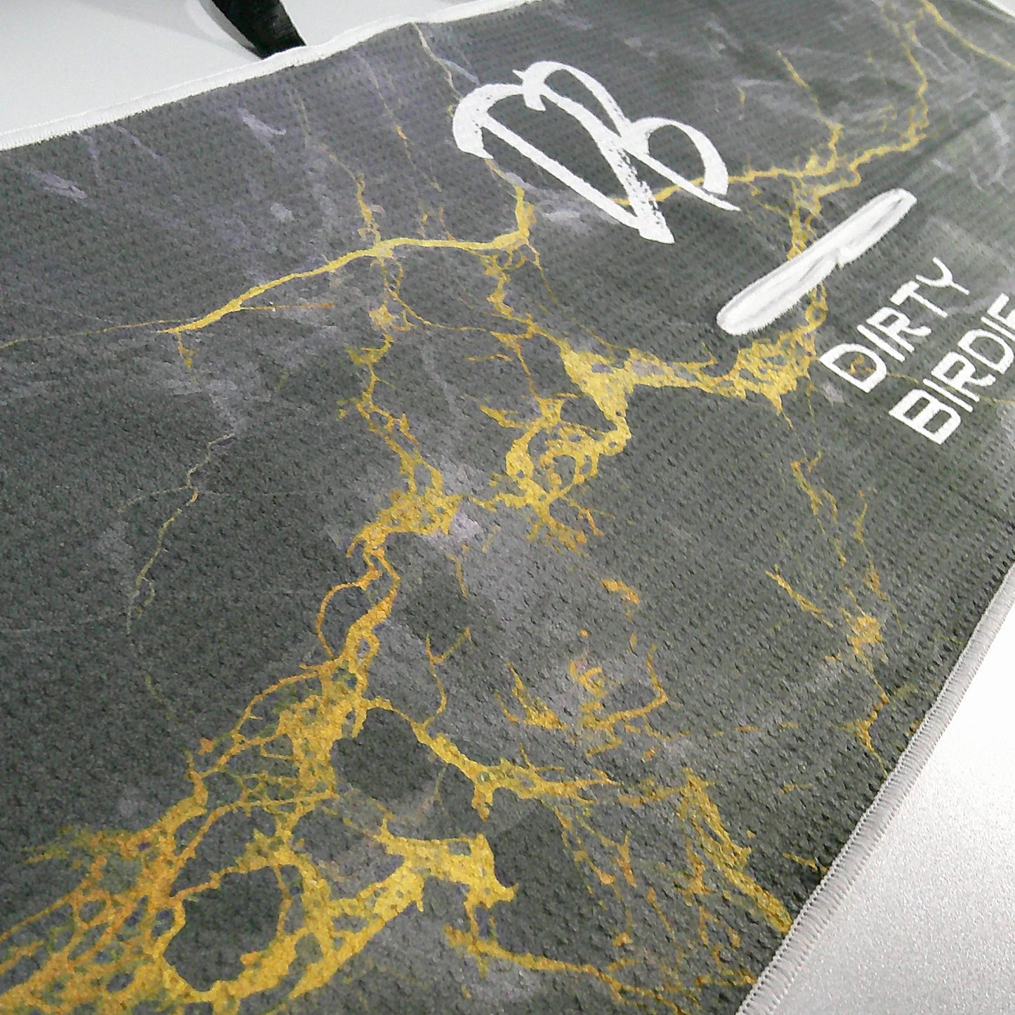 Detailed shot of Waffle knit Black Lightning golf towel showing material