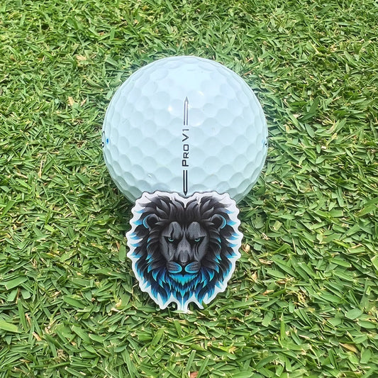 Close up of stylish Dirty Birdie Golf marker leaning against clean white golf ball on putting green.