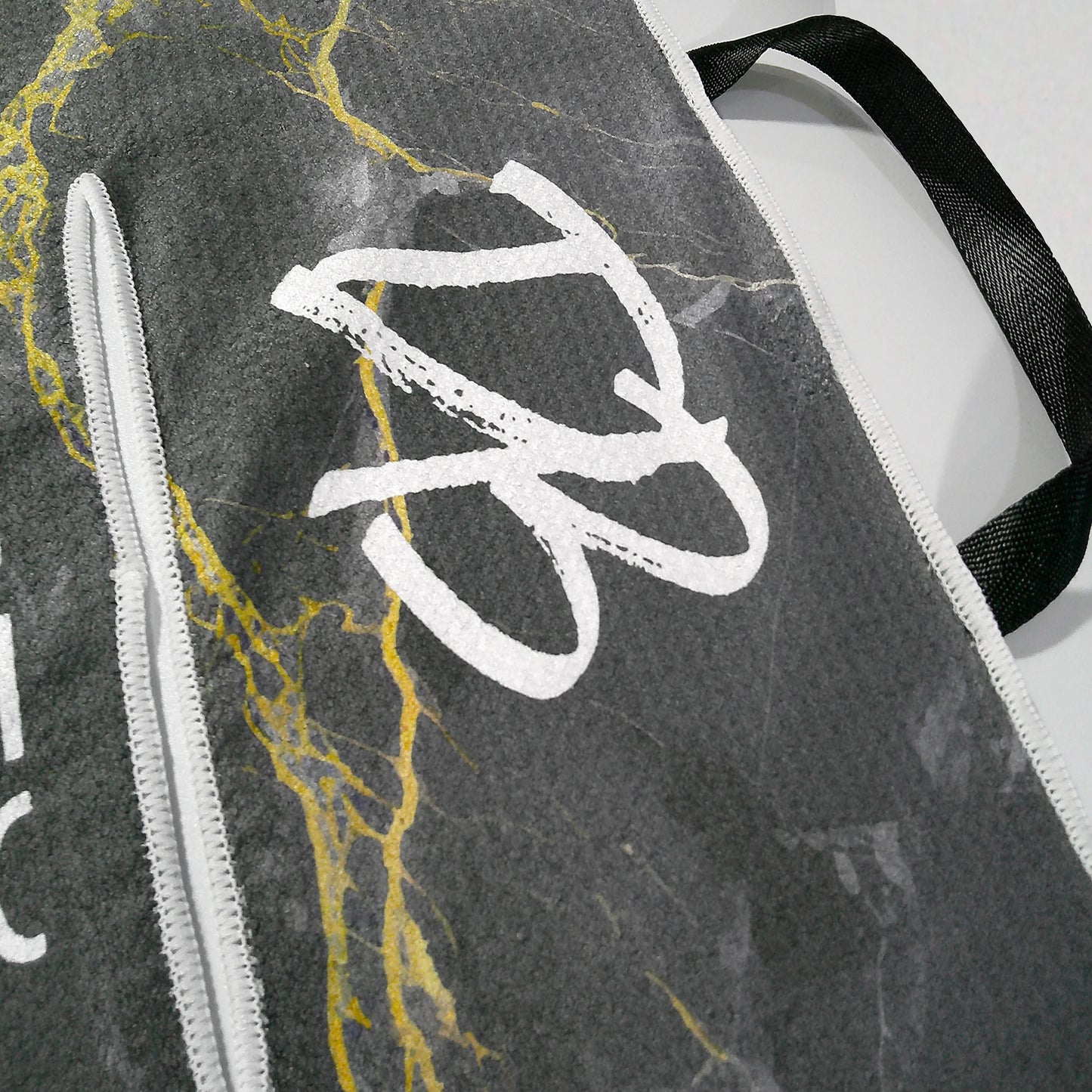 Close-up shot of Dirty Birdie golf towel logo and hoop