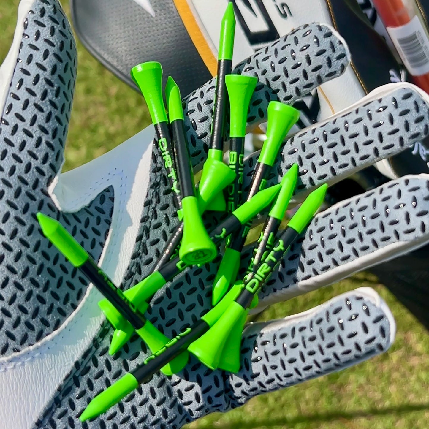 Handful of premium bamboo golf tees held in golfer’s palm before tee-off
