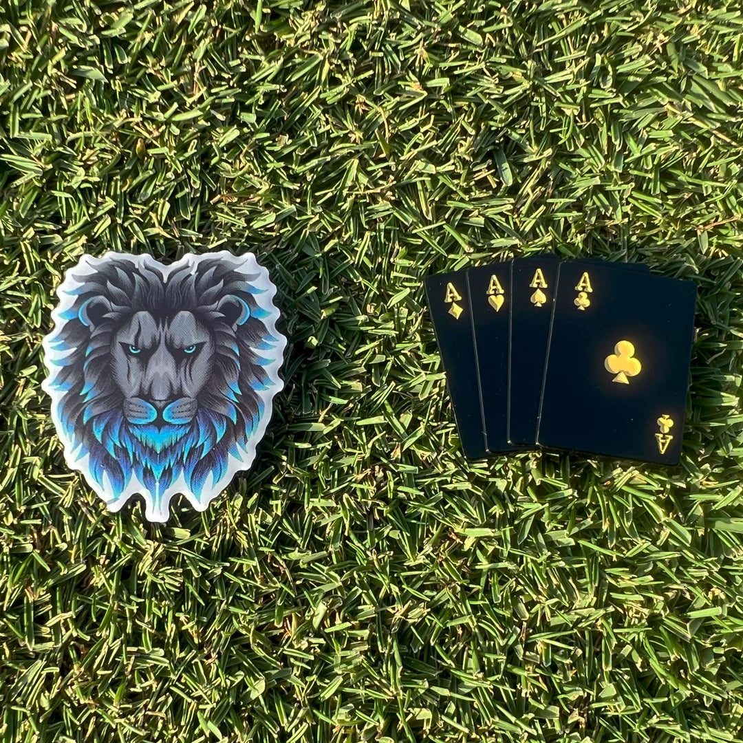 High Quality Lion mane and four aces ball laying flat on golf course putting green beside each other