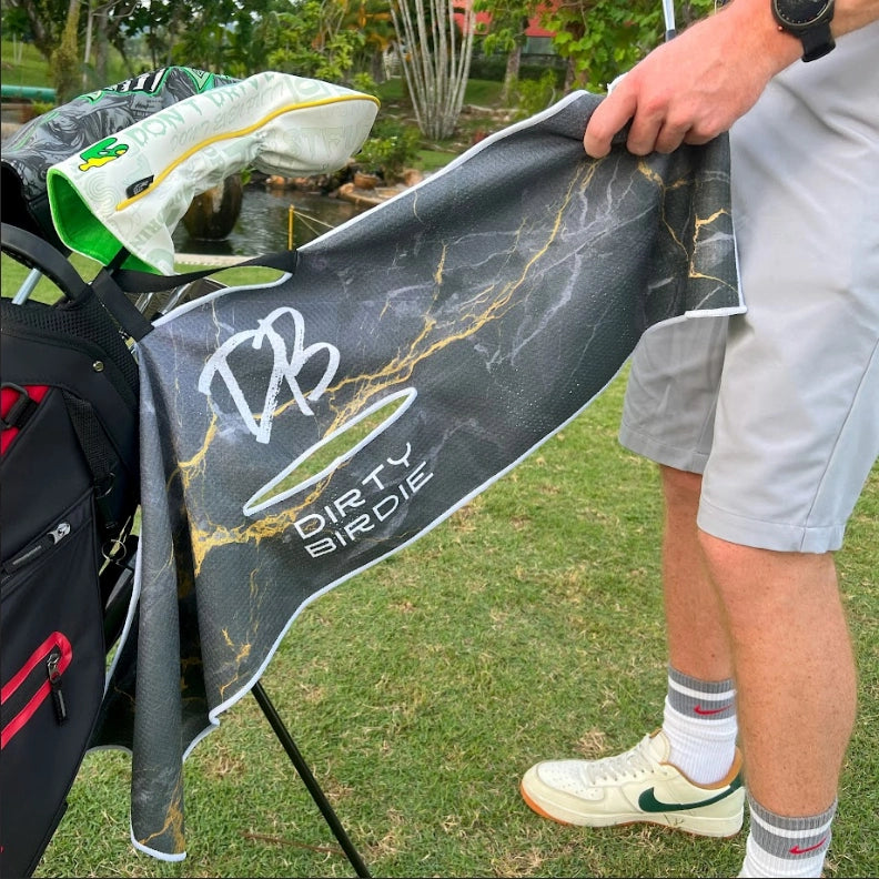 Black Lightning golf towel on bag mid-round, in use for club cleaning