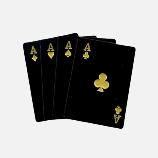Studio shot of Four Aces ball marker with bold black and gold design
