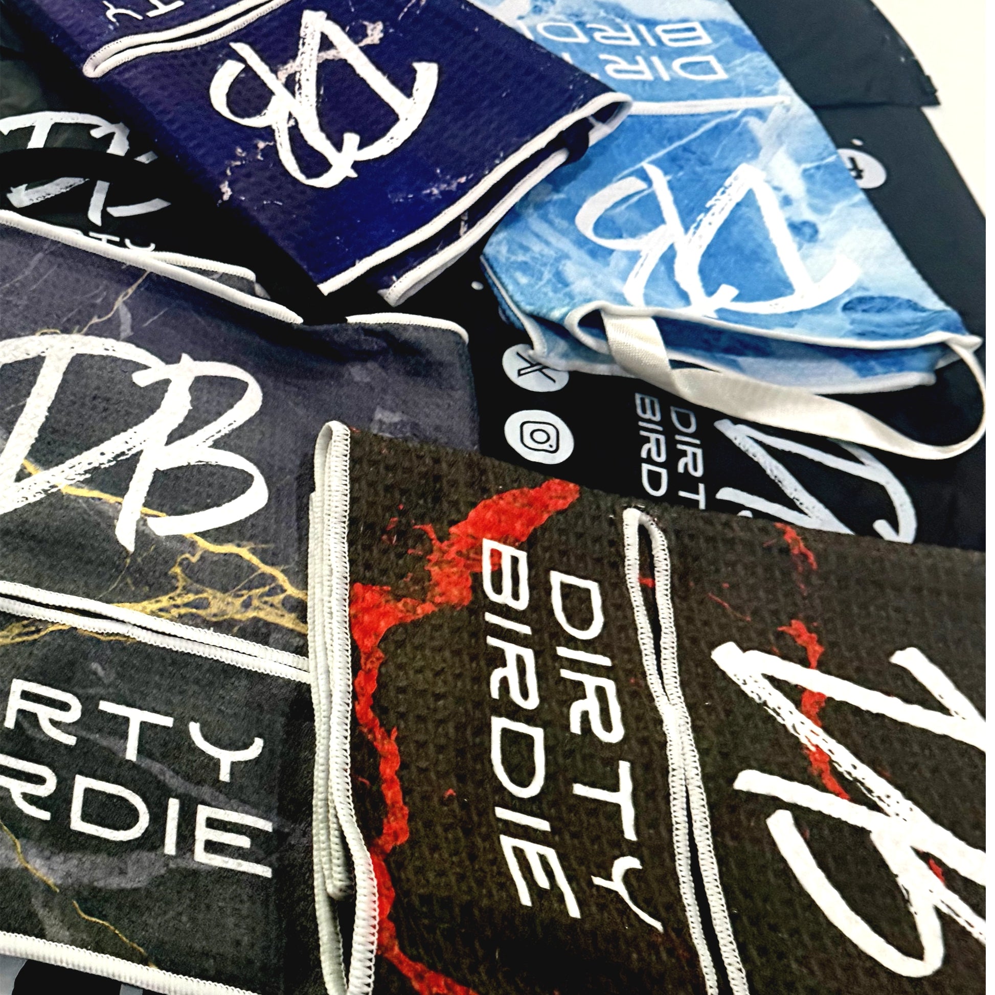 Collection of 'DIRT BIRDIE' branded products including towels and bags.