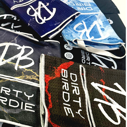 Collection of 'DIRT BIRDIE' branded products including towels and bags.