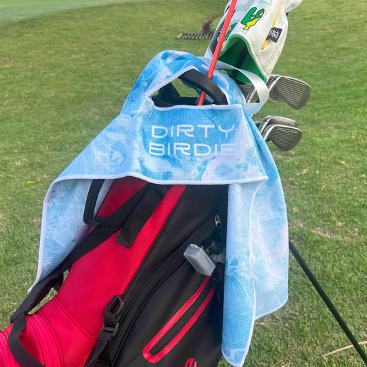 Blue Ice design golf towel draped over driver headcover
